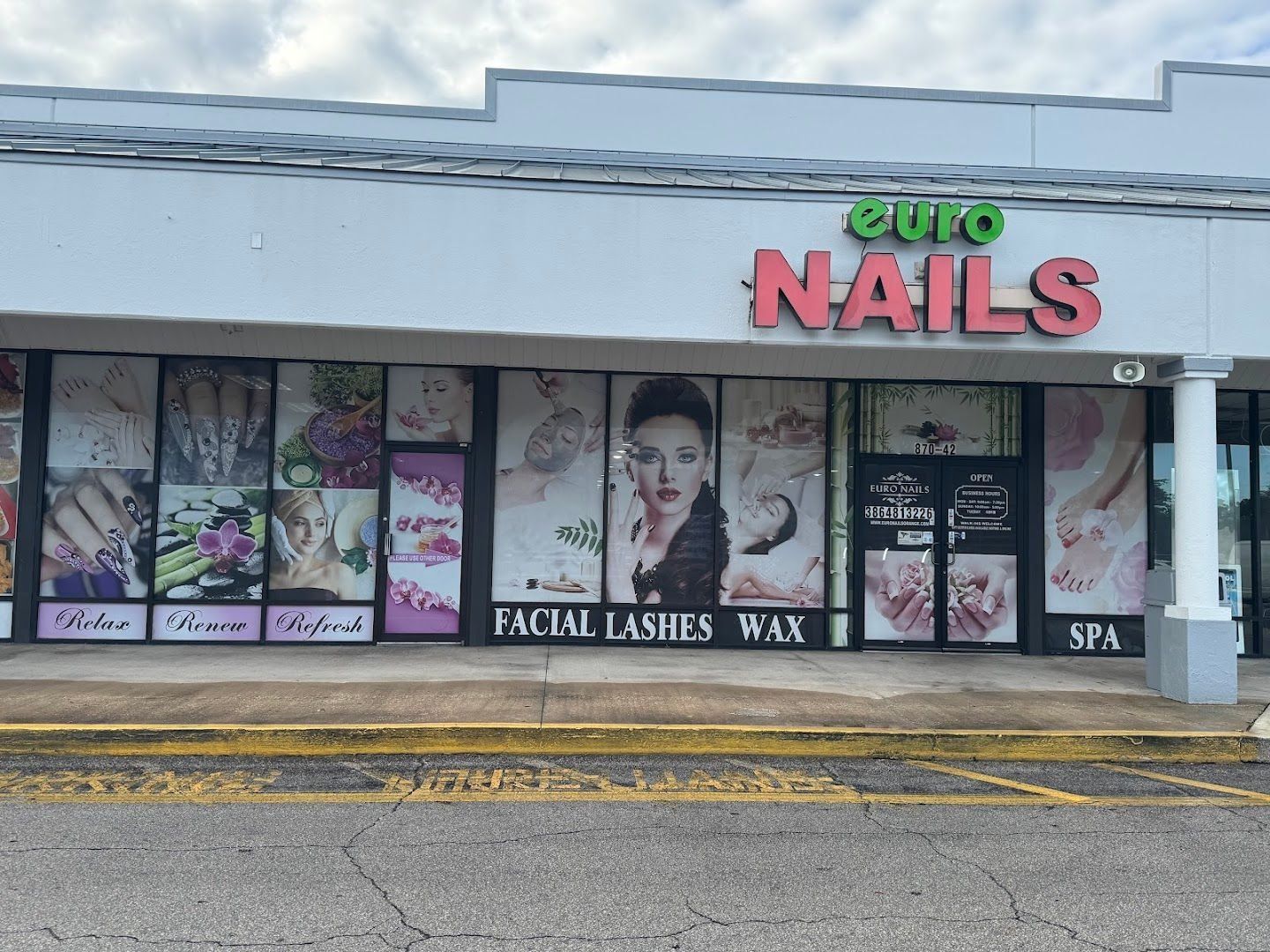 Outside Euro Nail Lounge — storefront with the euro NAILS sign and window displays for facial, lashes, wax, and spa