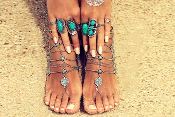 Mani and pedi combo at Euro Nail Lounge — matching manicured hands resting on pedicured feet with turquoise jewelry