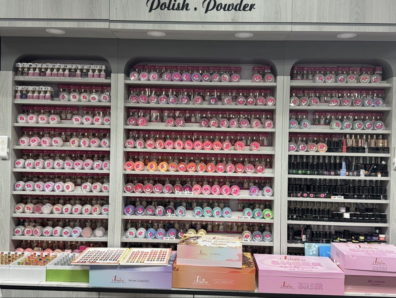 Dip powder color wall at Euro Nail Lounge — shelves of dip powder jars in hundreds of shades