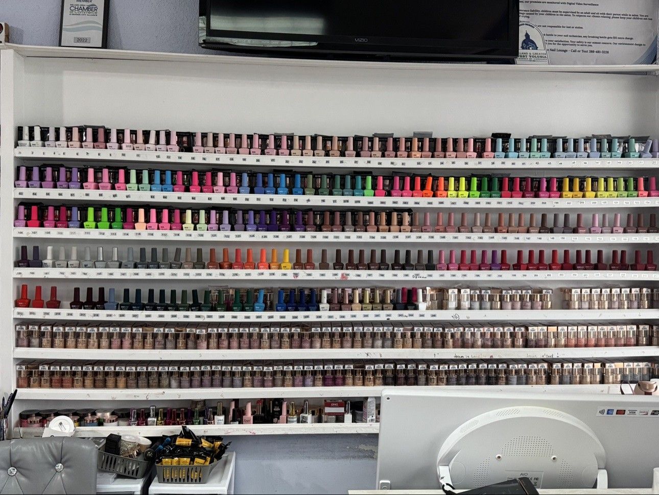 Gel polish wall at Euro Nail Lounge — numbered shelves holding over 200 gel polish shades