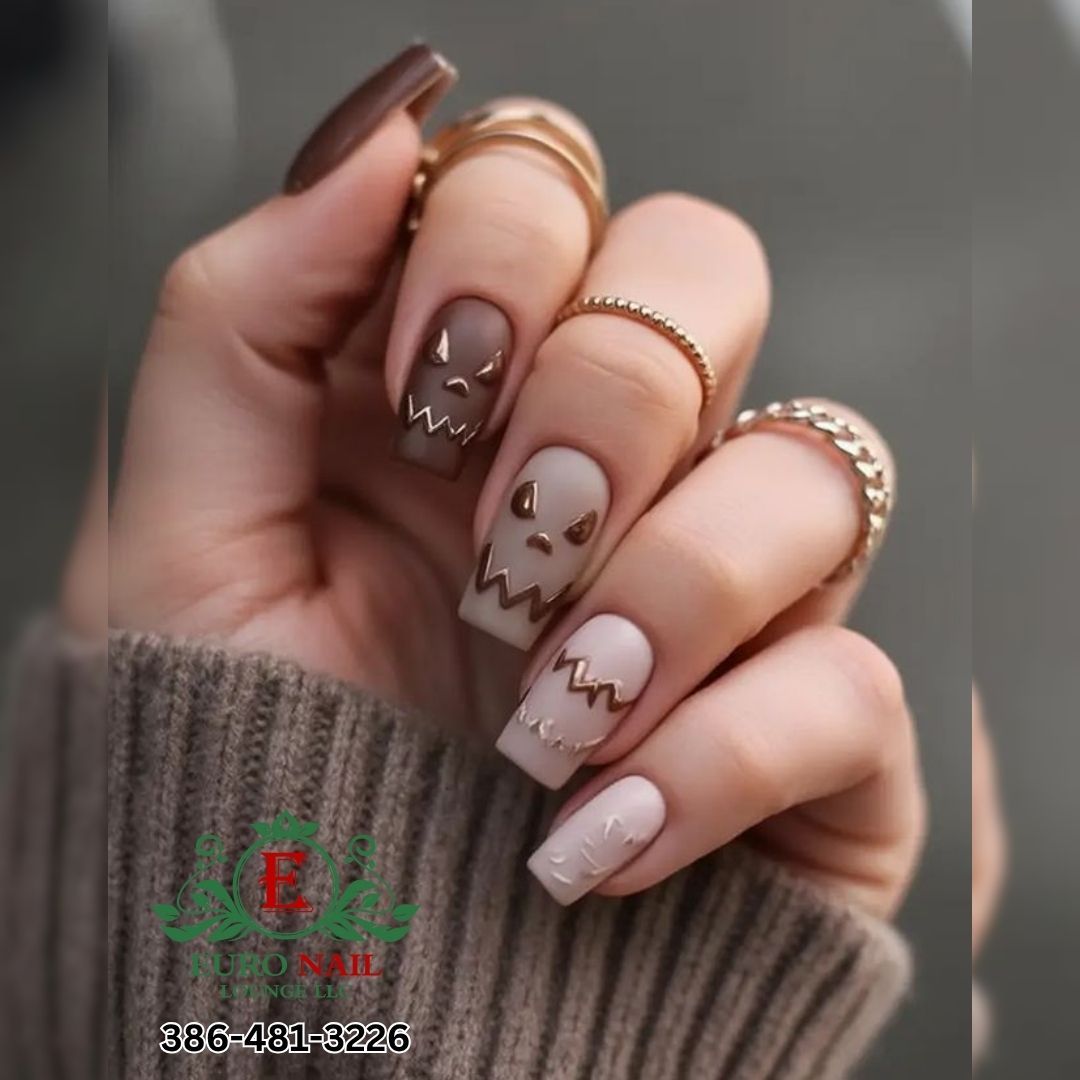 Halloween ghost nails at Euro Nail Lounge — brown and taupe coffin nails with jack-o-lantern ghost faces