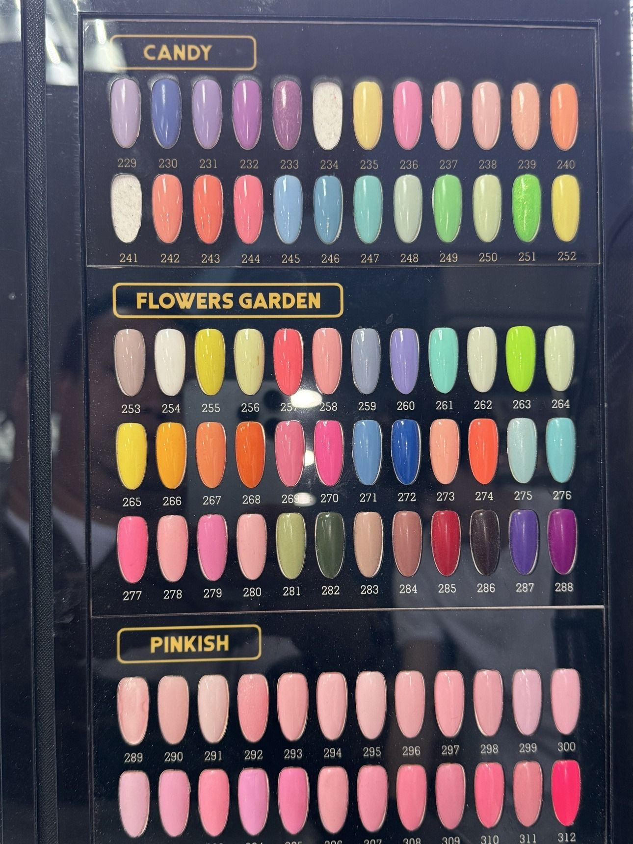 Solid Colors gel polish chart — Candy shades 229 to 252, Flowers Garden shades 253 to 288, and Pinkish shades 289 to 312