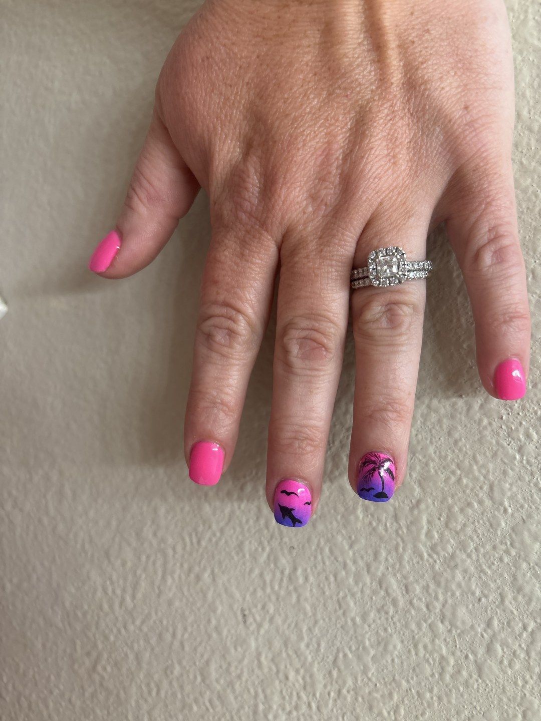Bright pink palm tree nails at Euro Nail Lounge — bright pink manicure with palm-tree nail art